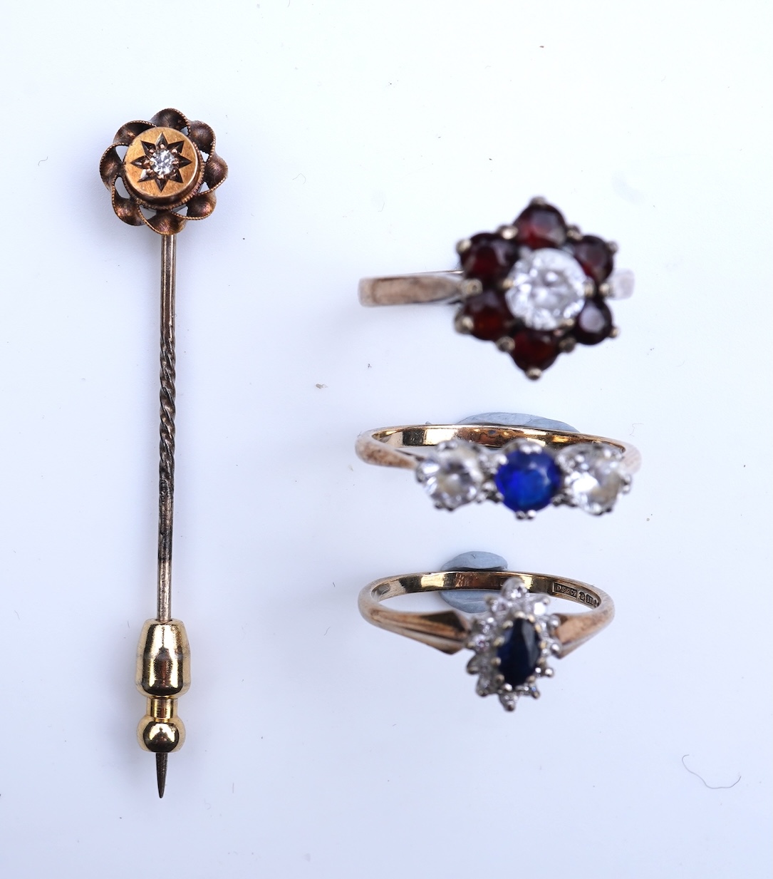 A group of three rings and a tie pin